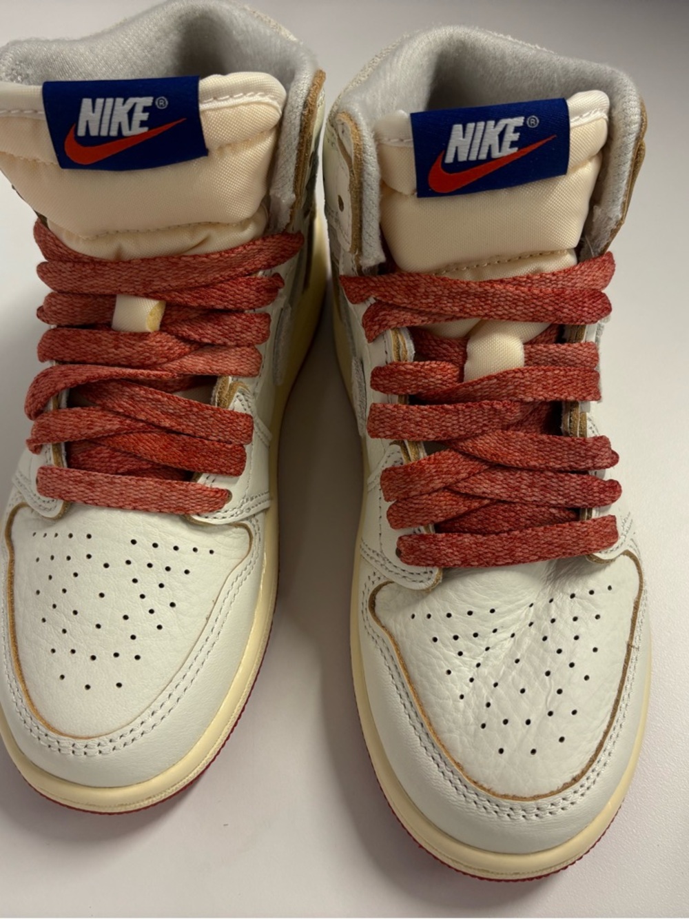 Nike Cream High-Tops with Red Laces and Blue Tongue Logo